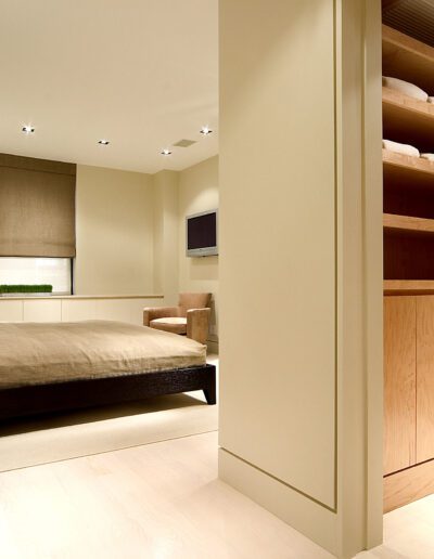 Modern bedroom interior with an adjoining walk-in closet.